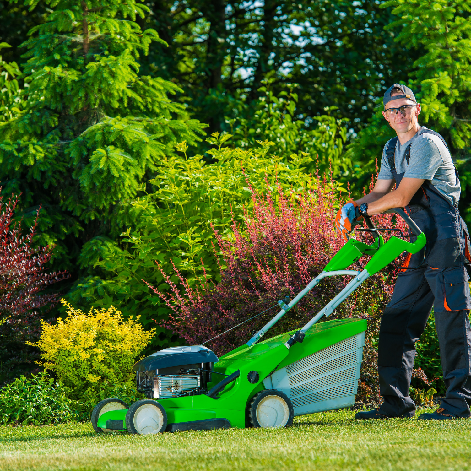man mowing lush green lawn
